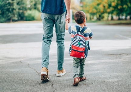Father walking son across street